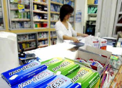 
A Singaporean pharmacist works behind her counter where Impress chewing gum is for sale Tuesday.A Singaporean pharmacist works behind her counter where Impress chewing gum is for sale Tuesday.
 (Associated PressAssociated Press / The Spokesman-Review)