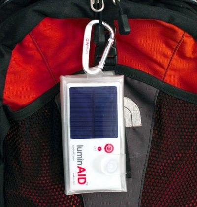 LuminAID clips on pack where it can charge.