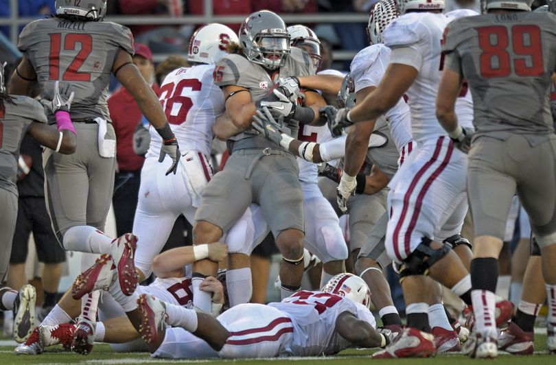 WSU linebacker Chester Su'a (45) holds on to his fumble recovery against Stanford at  Martin Stadium in Pullman, Oct. 15, 2011. (Christopher Anderson / Spokesman-Review)