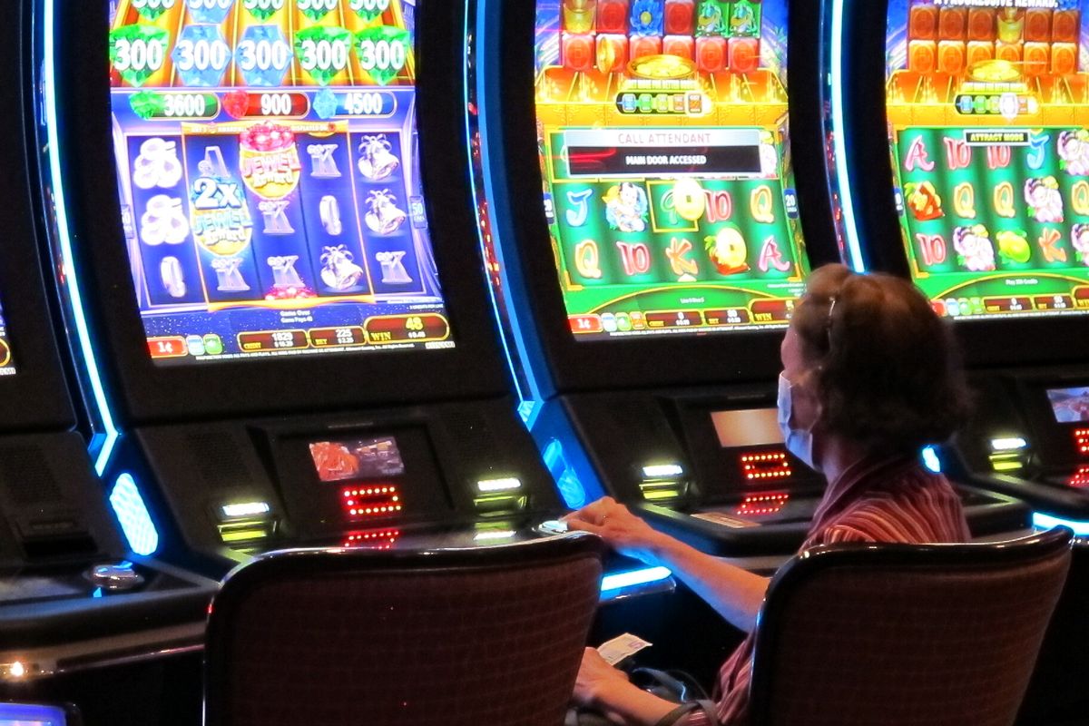 A woman plays a slot machine at the Golden Nugget casino in Atlantic City, N.J. on July 2, 2020. The U.S. gambling industry was a big winner at the polls on Nov. 3, 2020, with three states authorizing sports betting and three others either authorizing or expanding casino gambling.  (Wayne Parry)