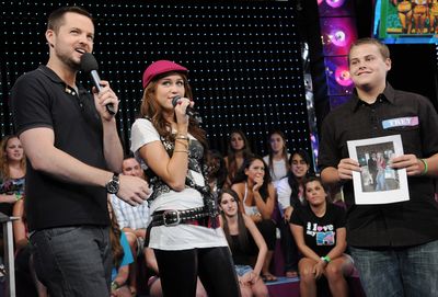 Actress-singer Miley Cyrus, center, co-hosts MTV’s Total Request Live with VJ Damien Fahey at MTV Studios in New York. Her taped appearance aired Thursday.Associated Pres photos (Associated Pres photos / The Spokesman-Review)