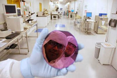 
Multispectral Imaging Inc. researchers Shankar Radhakrishnan, left, and Gregory Simelgor are  reflected in a disk in Cornell University's Nanoscale Science and Technology Facility in Ithaca, N.Y.Associated Press
 (Associated Press / The Spokesman-Review)