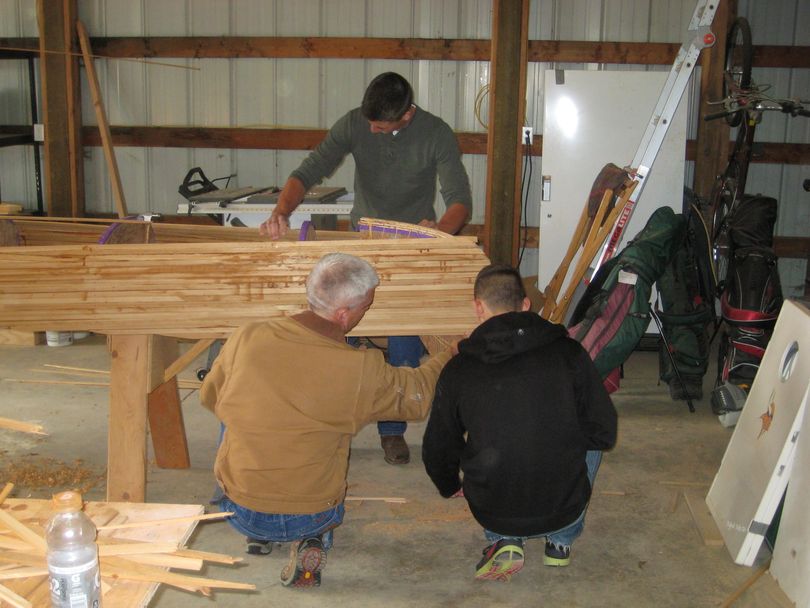 Gonzaga Prep wresting team members build a cedar strip canoe for their annual fund-raising raffle. (Courtesy)