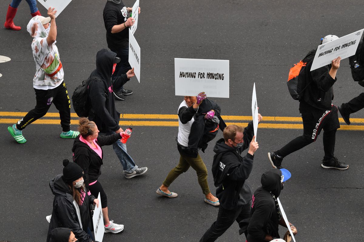 Demonstrators take to the streets of downtown Spokane during a Humans for Housing march held by Humanizing Spokane on Saturday, April 24, 2021, in Spokane, Wash.  (Tyler Tjomsland/The Spokesman-Review)