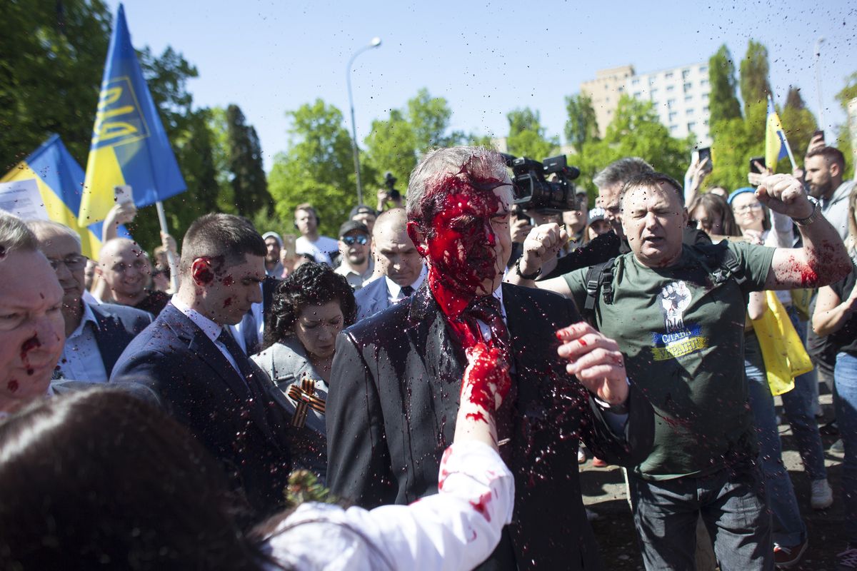 Russian Ambassador to Poland, Ambassador Sergey Andreev is covered with red paint in Warsaw, Poland, Monday, May 9, 2022. Protesters have thrown red paint on the Russian ambassador as he arrived at a cemetery in Warsaw to pay respects to Red Army soldiers who died during World War II. Ambassador Sergey Andreev arrived at the Soviet soldiers cemetery on Monday to lay flowers where a group of activists opposed to Russia’s war in Ukraine were waiting for him.  (Maciek Luczniewski)