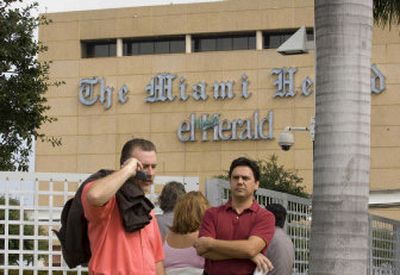 
Workers and bystanders mingle Friday after Miami Herald newspaper offices  were  evacuated.  Jose Varela, a cartoonist for El Nuevo Herald,  entered the  building with a toy gun that appeared to be real and demanded to speak with an editor of the Spanish-language paper. 
 (Associated Press / The Spokesman-Review)