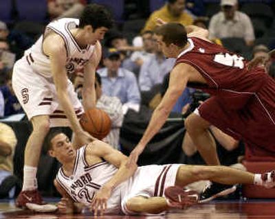 
Stanford's Taj Finger, left, picks up a loose ball behind teammate Nick Robinson, center, and next to Washington State's Chris Schlatter during the first half of the teams' Pac-10 tournament game. 
 (Associated Press / The Spokesman-Review)