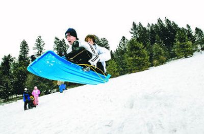 
Justin Arts and Luke Lott, both 16, shoot off a small jump at Cherry Hill Park in Coeur d'Alene while sledding with friends Jan. 9. The park, one of 17 in the city, includes the sledding hill, a themed playground, tennis courts and a BMX track. 
 (Jesse Tinsley / The Spokesman-Review)