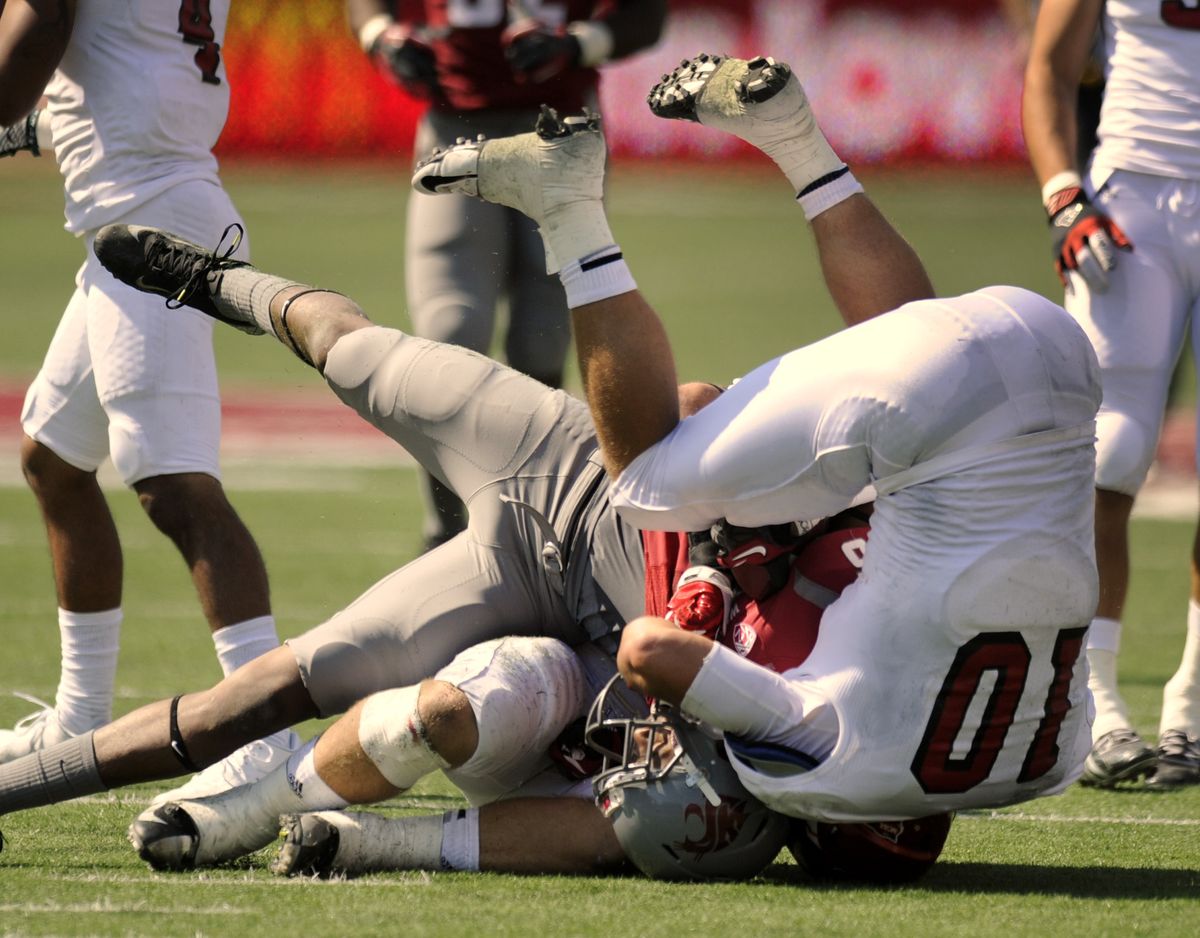 Marquess Wilson is tackled by EWU’s Zach Johnson (10). Wilson had a TD catch nullified by a holding call for the second straight game. (Colin Mulvany)