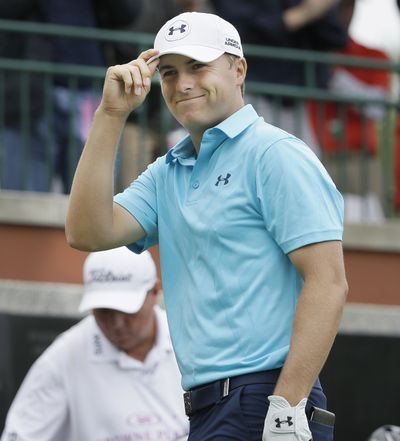 Jordan Spieth tips his hat to the gallery after his introduction before his tee shot on the first hole at the Colonial. (Associated Press)