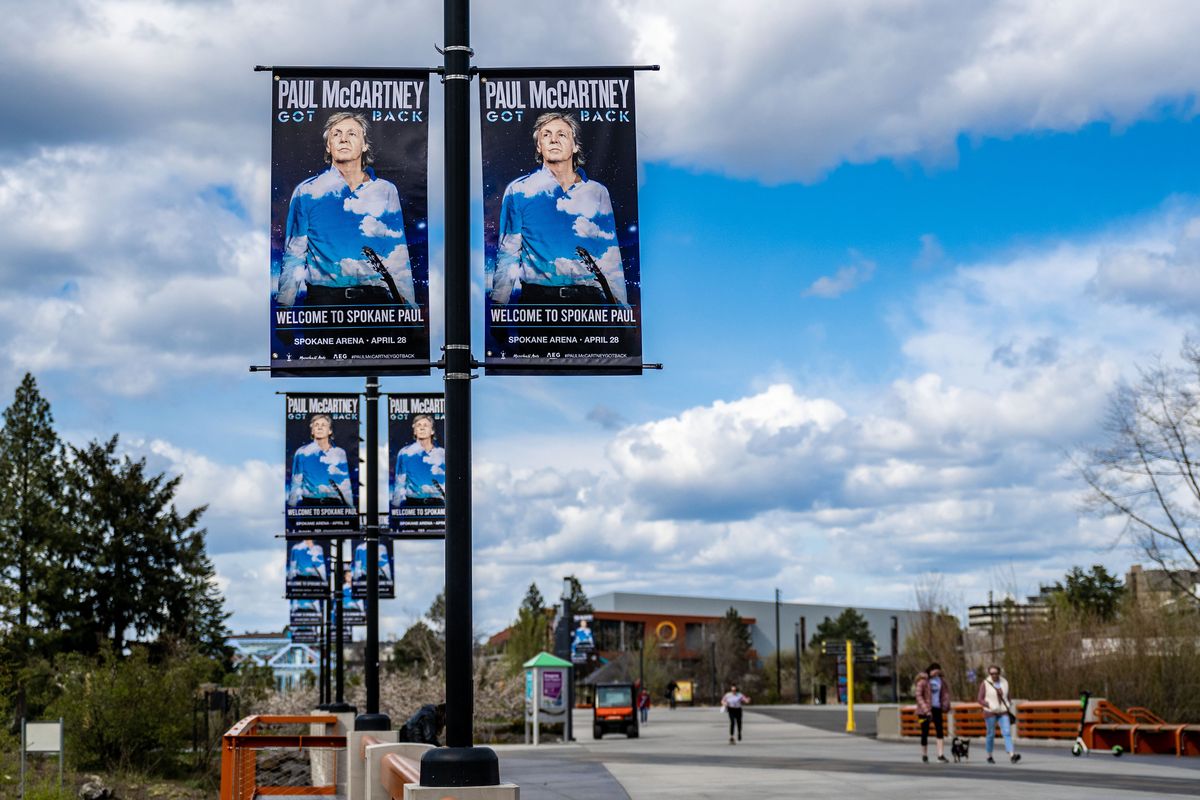 In the clouds: Banners welcoming Paul McCartney to Spokane, ahead of his Thursday concert, line the pedestrian bridge Tuesday in Riverfront Park. Fans are bringing wish lists with them, hoping McCartney might play one of their favorites from his vast and enduring collection of songs spanning seven decades. (COLIN MULVANY/THE SPOKESMAN-REVI)