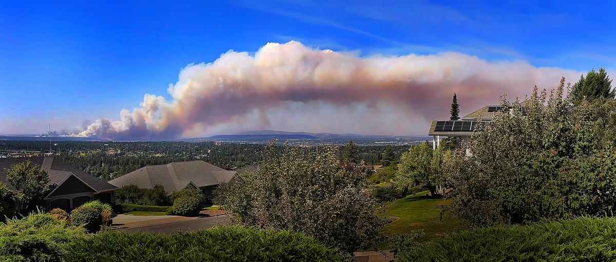 A huge plume of smoke from the Old Trails Fire blots out a beautiful Saturday sky as multiple fires cause damage and stretch fire resources to the limit on Saturday, Aug. 1 2026, in Spokane. This view is from southeastern Spokane looking north with the plume of smoke heading east.  (Christopher Anderson/For The Spokesman-Review)