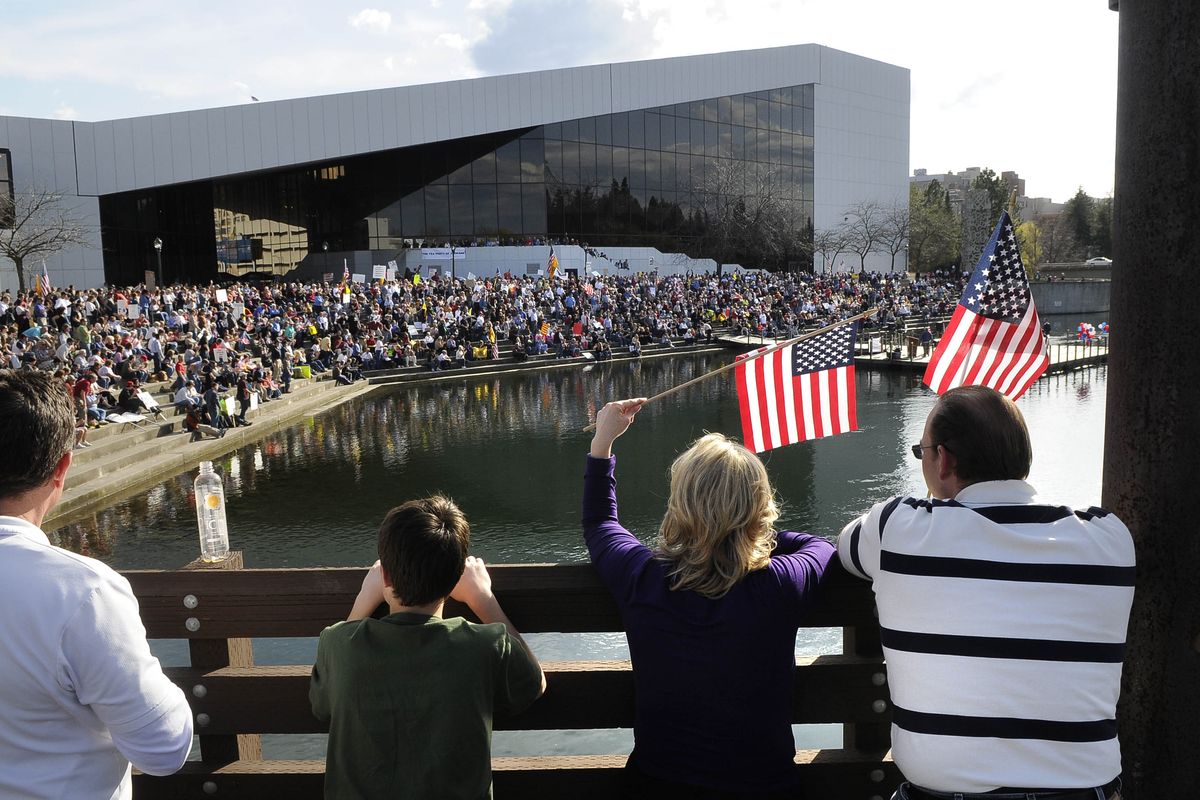 Crowds lined the wood foot bridge and the steps at the Spokane Convention Center to hear speakers on the floating stage at the Tea Party rally on Thursday, April 15, 2010, in Riverfront Park. (Dan Pelle / The Spokesman-Review)