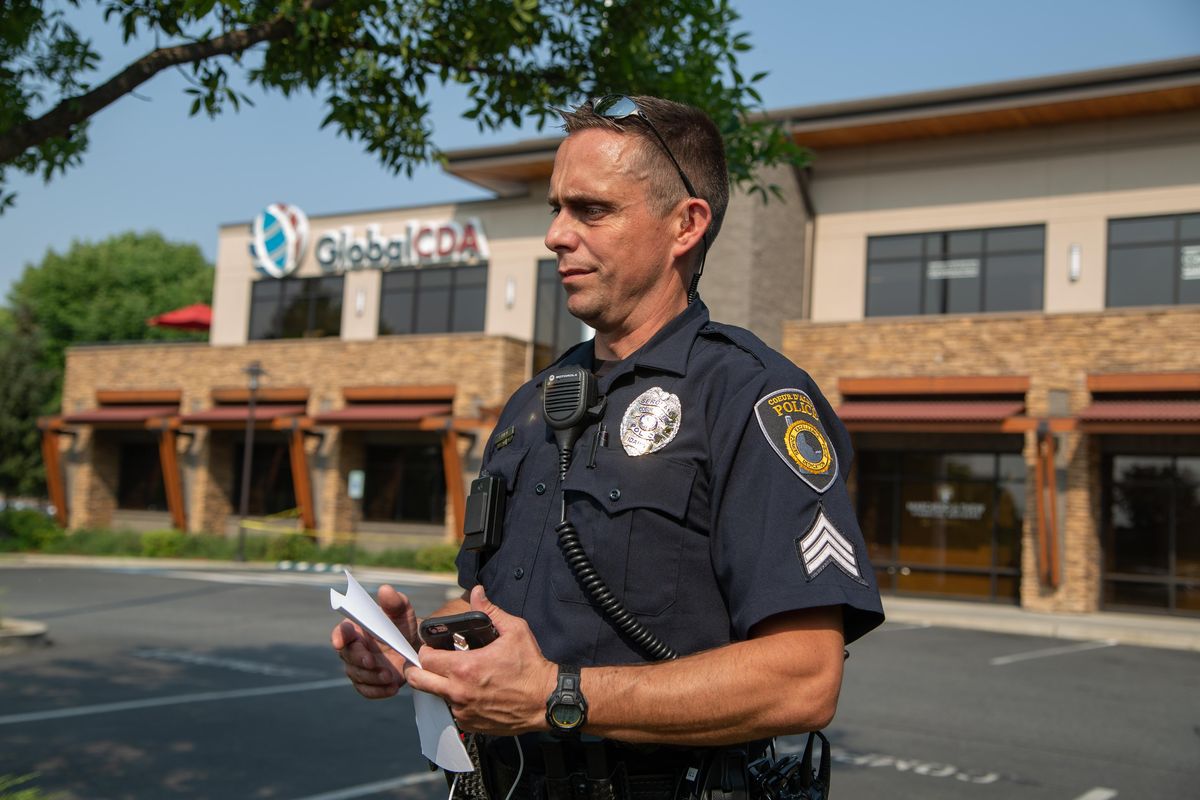 Coeur d’ Alene Police Detective Jared Reneau speaks outside of the Global Credit Union Coeur d’Alene branch, where a suspect died on Aug. 11, 2018 after recieving fire from an armed security guard. (Libby Kamrowski / The Spokesman-Review)