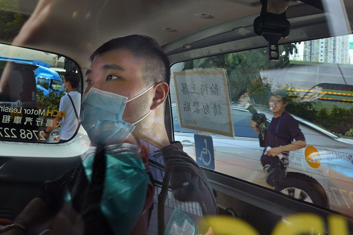 FILE - In this July 6, 2020, file photo, Tong Ying-kit arrives at a court in a police van in Hong Kong. Hong Kong High Court will deliver verdict Tuesday afternoon, July 27, 2021 for the first person charged under Hong Kong
