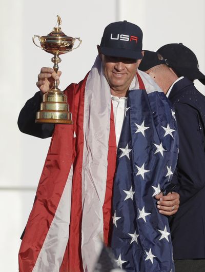 United States captain Davis Love III holds up the Ryder Cup during the closing ceremony on Sunday at Hazeltine National Golf Club in Chaska, Minn. (Chris Carlson / Associated Press)