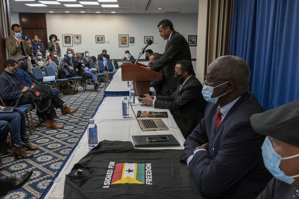 Mahamud Ugas, center, speaks during signing ceremony of the United Front of Ethiopian Federalist and Confederalist Forces to establish a grand United Front to fight against the Abiy Ahmed regime in Ethiopia, in Washington, Friday, Nov. 5, 2021. Ethiopia’s Tigray forces on Friday joined with other armed and opposition groups around the country in an alliance against Prime Minister Abiy Ahmed to seek a political transition after a year of devastating war, and they left the possibility open for his exit by force.  (Gemunu Amarasinghe)