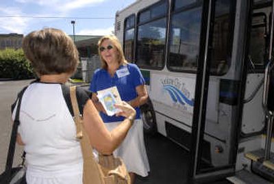 
Susan Bauguss, right, of Spokane City Tours welcomes Kathy Piper to the tour bus leaving from downtown Spokane. 
 (Dan Pelle / The Spokesman-Review)