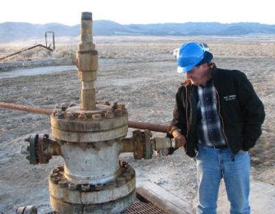 
U.S. Geothermal president of operations Chris Harriman opens a valve on an injection well Nov. 1 at the company's Raft River site in Idaho.  A power plant is due to be completed late next year. 
 (Associated Press / The Spokesman-Review)