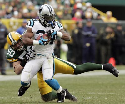 A.J. Hawk (50) and the Packers had trouble stopping DeAngelo Williams, who scored four touchdowns for the Panthers. (Associated Press / The Spokesman-Review)