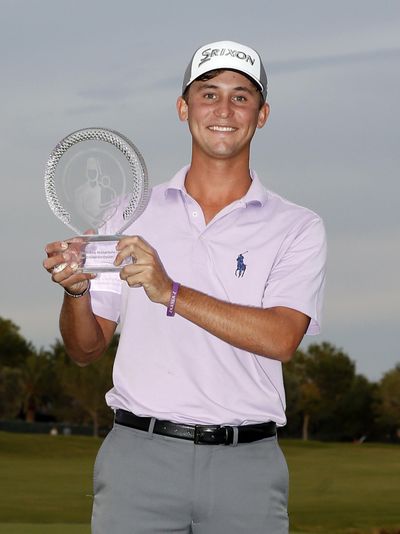 Smylie Kaufman hoists the trophy after winning the Shriners Hospitals for Children Open golf tournament Sunday, Oct. 25, 2015, in Las Vegas. (Isaac Brekken / Associated Press)