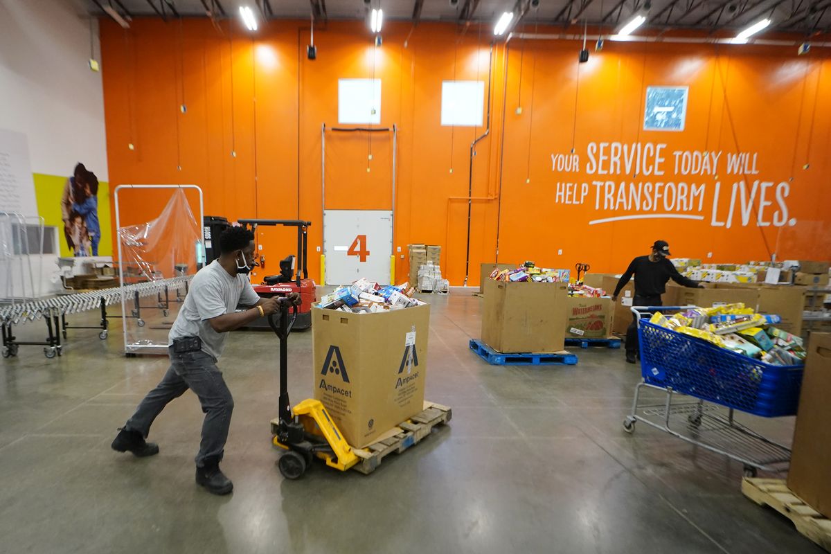 Volunteer group leader Bruce Beecham works to sort food items in the Atlanta Food Bank
