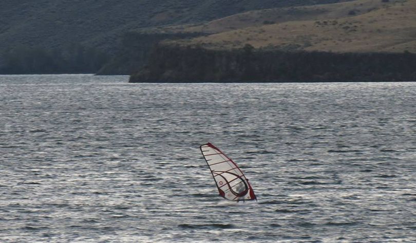 Boise windsurfer Chris Lee flies across Lucky Peak lake shortly after sunrise on Thursday; conditions for early-morning windsurfing and kite-sailing there have been ideal for what appears to be at least a four-day stretch. (Tom von Alten photo)