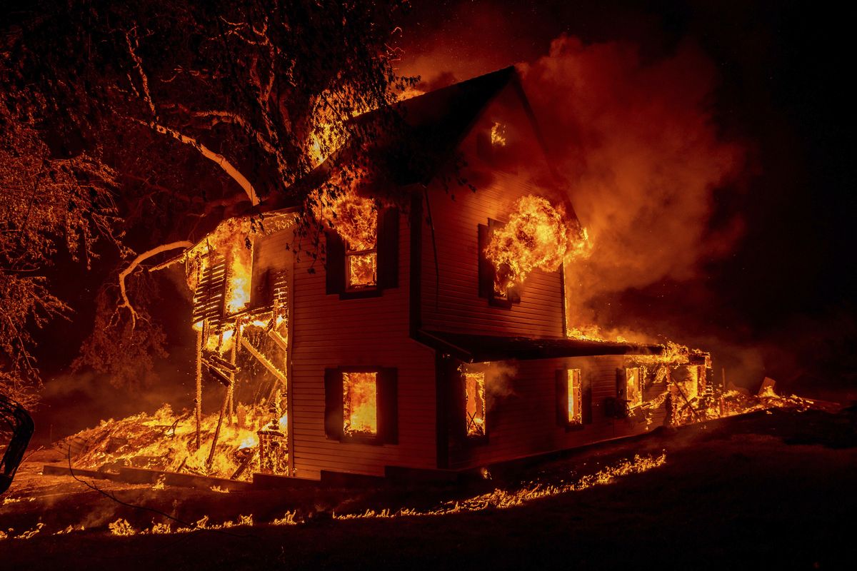 A home burns on Jeters Road as the Dixie fire jumps Highway 395 south of Janesville, Calif., on Monday. Critical fire weather throughout the region threatens to spread multiple wildfires burning in Northern California.  (Ethan Swope)