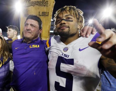 In this Oct. 2017 photo, LSU head coach Ed Orgeron, left, celebrates with running back Derrius Guice following a win in Oxford, Miss. A 74-year-old woman told state lawmakers she spoke directly to Orgeron about sexual harassment she endured in 2017 from one of his star players. But the woman, a grandmother, said Orgeron did nothing to reprimand then-LSU running back Guice when the player allegedly harassed her while she working at her Superdome security job in 2017.  (Associated Press)