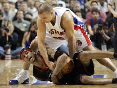 
Philadelphia guard Allen Iverson (bottom) and Detroit forward Carlos Arroyo fight for possession during the second quarter. 
 (Associated Press / The Spokesman-Review)