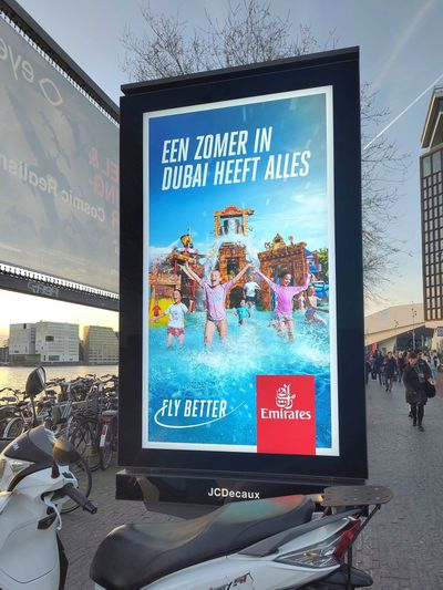 An advertisement for travel in Amsterdam. The Dutch city has outlawed advertising that promotes lifestyles linked to high carbon emissions, which is a driver of climate change. It’s a first for a world capital.  (Femke Sleegers/Fossil Free Advertising via The New York Times)