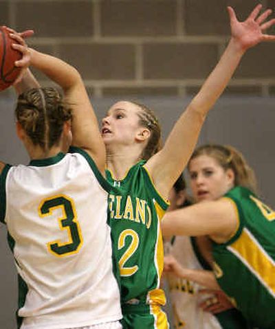 
Lakeland guard Jessie Bartlett gets a hand in the face of Bonneville's Amy Passey (3) during the first half of the State 4A semifinal game. 
 (Matt Cilley/Special to / The Spokesman-Review)
