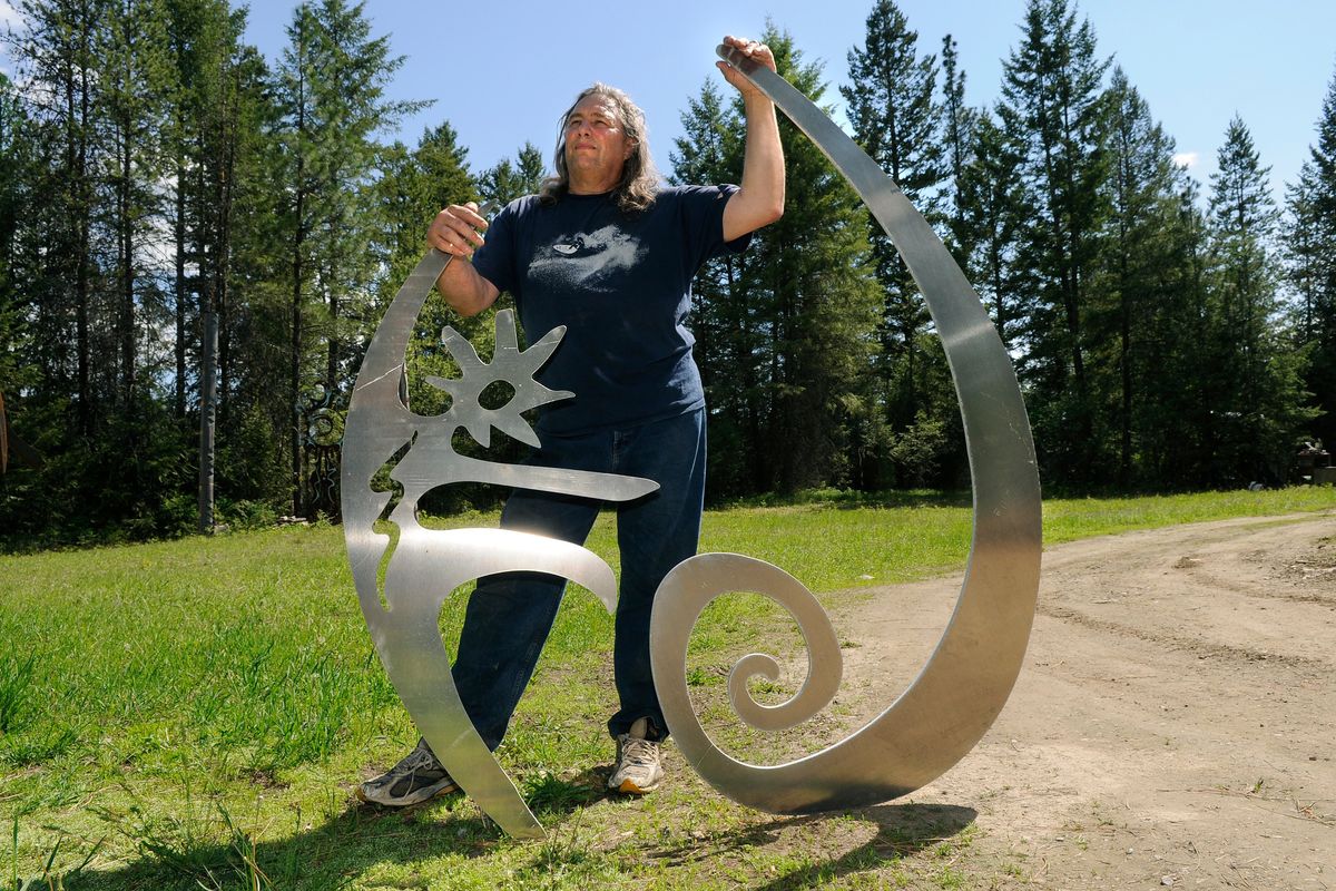 Artist David Govedare, seen here in this 2008 photo, was famous in part for creating “The Joy of Running Together” sculpture in downtown Spokane. Here he holds art that was later installed at Rogers High School.  (Dan Pelle/The Spokesman-Review)