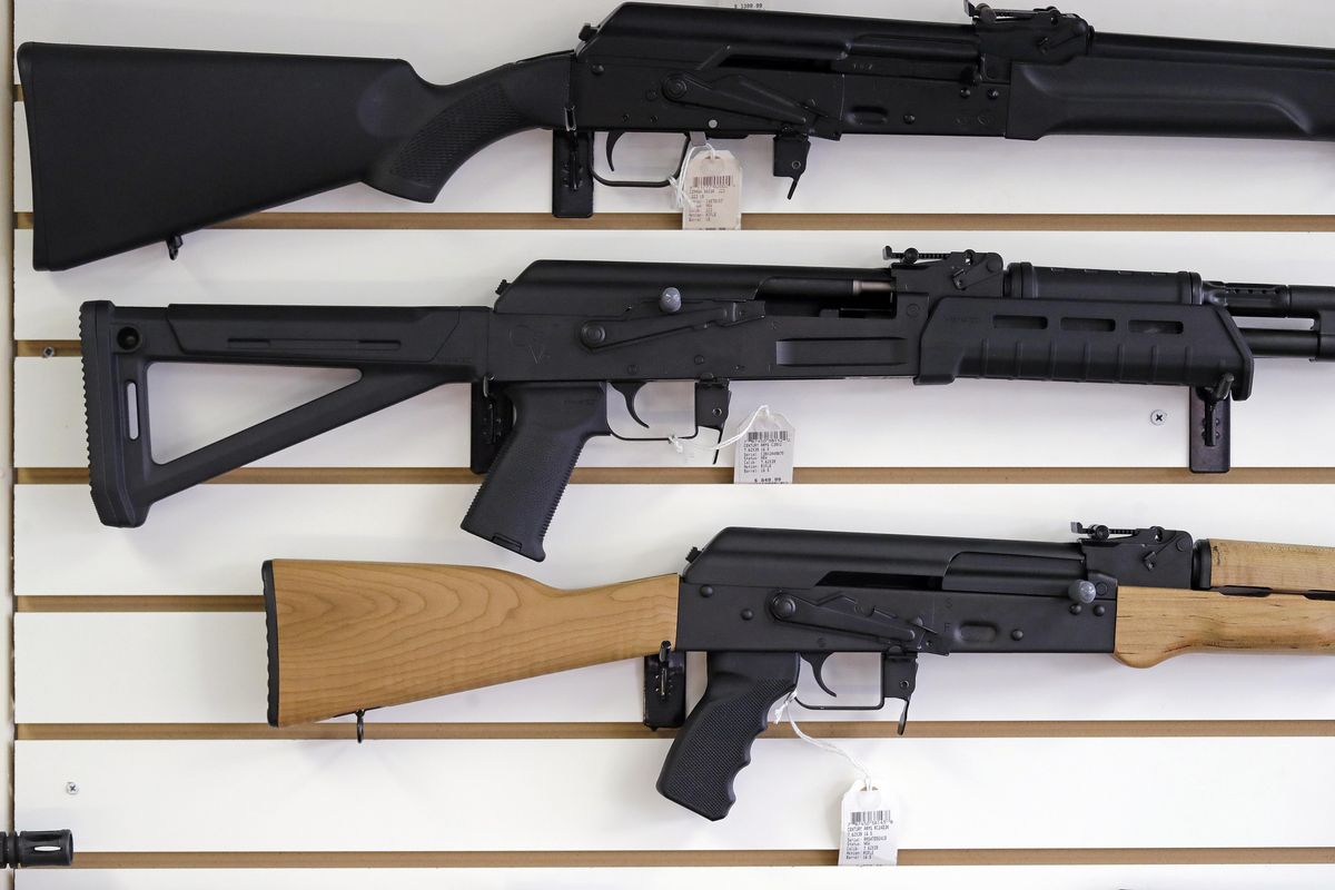 In this Oct. 2, 2018, file photo, semi-automatic rifles are displayed on a wall at a gun shop in Lynnwood, Wash. A bill passed to create the Washington Office of Firearm Safety and Violence Prevention passed the House on a 53-44 vote Thursday and was sent to Gov. Jay Inslee to sign. (Elaine Thompson / AP)