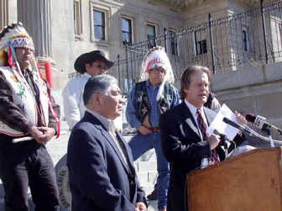 
Shoshone-Bannock attorney Bill Bacon, right, stands Tuesday at the Capitol in Boise holding a copy of the lawsuit the tribes intend to file if the Nez Perce water rights agreement is approved. The agreement is headed for a final vote in the Senate. 
 (Associated Press / The Spokesman-Review)