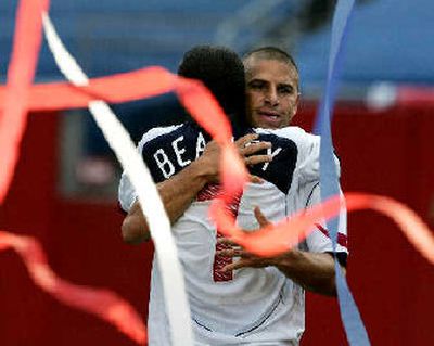 
DaMarcus Beasley is hugged by Chris Armas after scoring the Americans' third goal.
 (Associated Press / The Spokesman-Review)