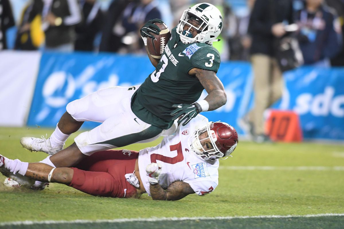 Michigan State Spartans running back LJ Scott (3) runs for a touchdown against Washington State Cougars defensive back Robert Taylor (2) during the second half of the 2017 Holiday Bowl Thursday, December 28, 2017, at SDCCU Stadium in San Diego, Calif. Michigan State won the game 42-17. (Tyler Tjomsland / The Spokesman-Review)