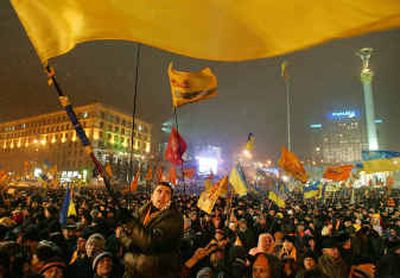 
Supporters of Ukrainian opposition leader Viktor Yushchenko hold a mass rally as Yushchenko, unseen, speaks on stage in the main square of Kiev on Monday. 
 (Associated Press / The Spokesman-Review)