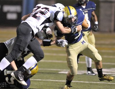 Mead's Austin Stone, right, tries to make a move around North Central's Jimmy Weigel during Friday's GSL game at Albi Stadium. (Jesse Tinsley)