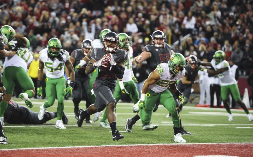 WSU running back and captain Jamal Morrow “has an amazing knack for winning the (coin) toss,” according to coach Mike Leach. (Tyler Tjomsland / The Spokesman-Review)