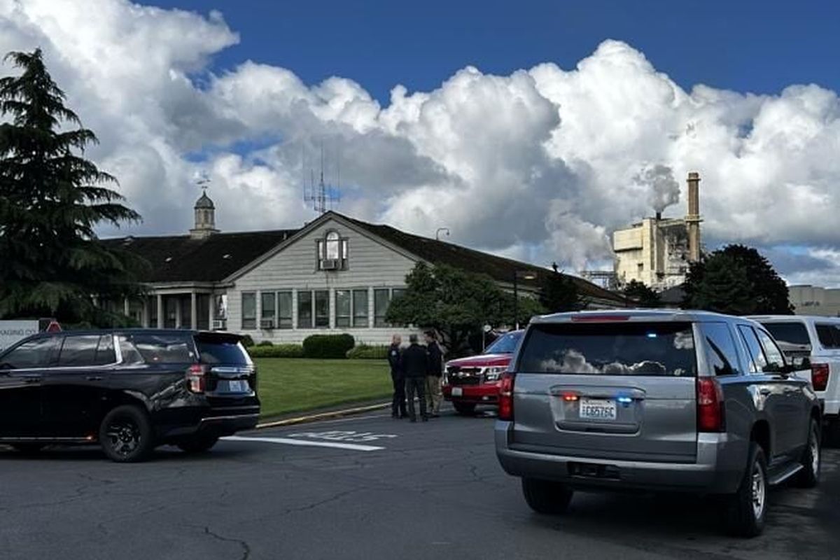 Officials, including Longview Police Chief Robert Huhta, talk outside Nippon on Tuesday, May 26, in Longview after a reported implosion at the pulp and paper mill. (Matt Esnayra/(Longview) Daily News)