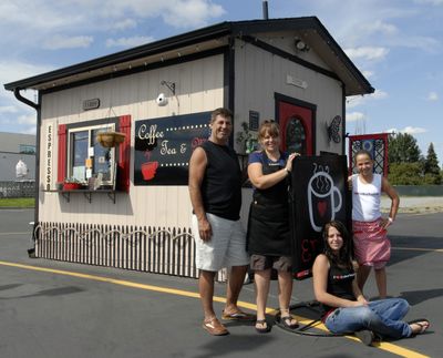 Paula Hyatt and her husband Don and their children Sunshine, 10, (standing) and Hope, 18, have opened  Coffee, Tea & Me at 11809 E. Sprague Ave. (J. BART RAYNIAK / The Spokesman-Review)