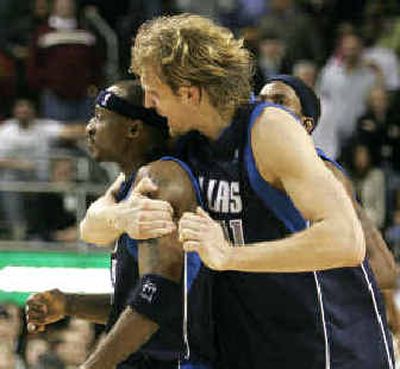
Mavs' Jason Terry, left, gets a victory hug from Dirk Nowitzki. 
 (Associated Press / The Spokesman-Review)