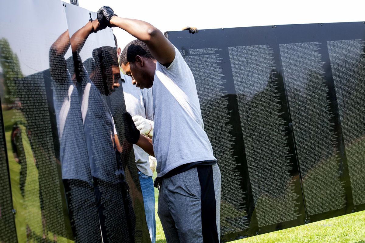 Arthur Kidd of the 97 MXS ammunition flight from Fairchild Air Force Base volunteered to help set up the traveling Vietnam Memorial wall at Mirabeau Park in Spokane Valley on Wednesday, August 23, 2017. (Kathy Plonka / The Spokesman-Review)