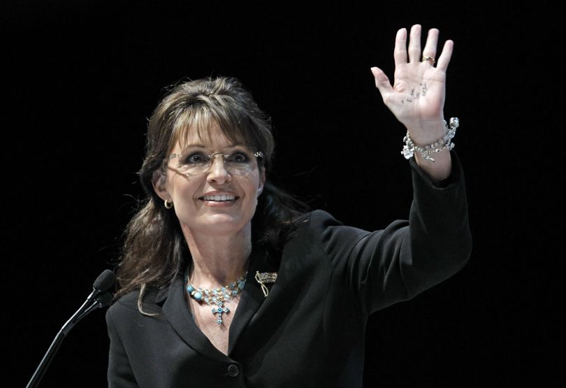 Former Alaska Gov. Sarah Palin shows her hand with the saying 