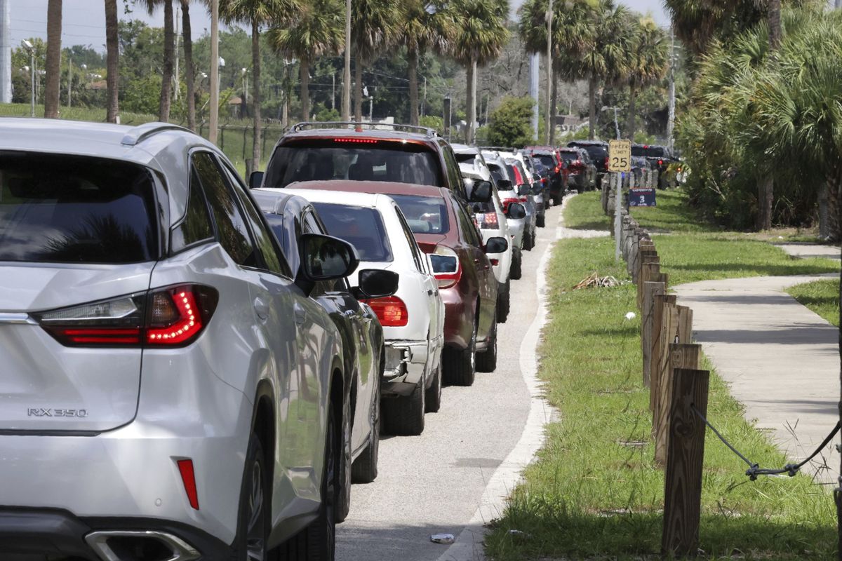Cars wait in line for COVID-19 testing at Barnett Park, in Orlando, Fla., Thursday, July 29, 2021. The line stretched through the park for more than a mile to the entrance to the Central Florida Fairgrounds. Orange County is under a state of emergency as coronavirus infections skyrocket in Central Florida. The Barnett Park site is testing 1,000 people a day and has closed early in recent days due to reaching capacity.  (Joe Burbank)