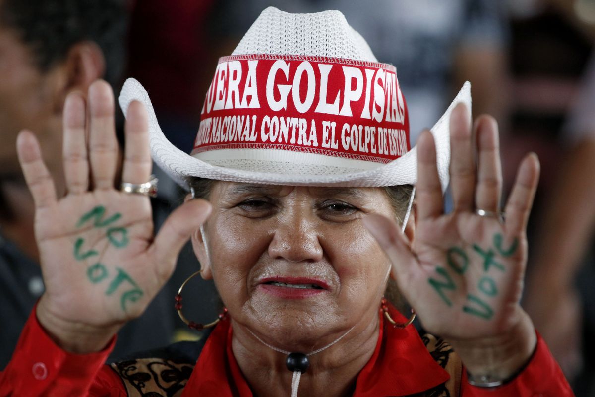 A backer of  ousted Honduran President Manuel Zelaya shows her support with her hands on Monday.