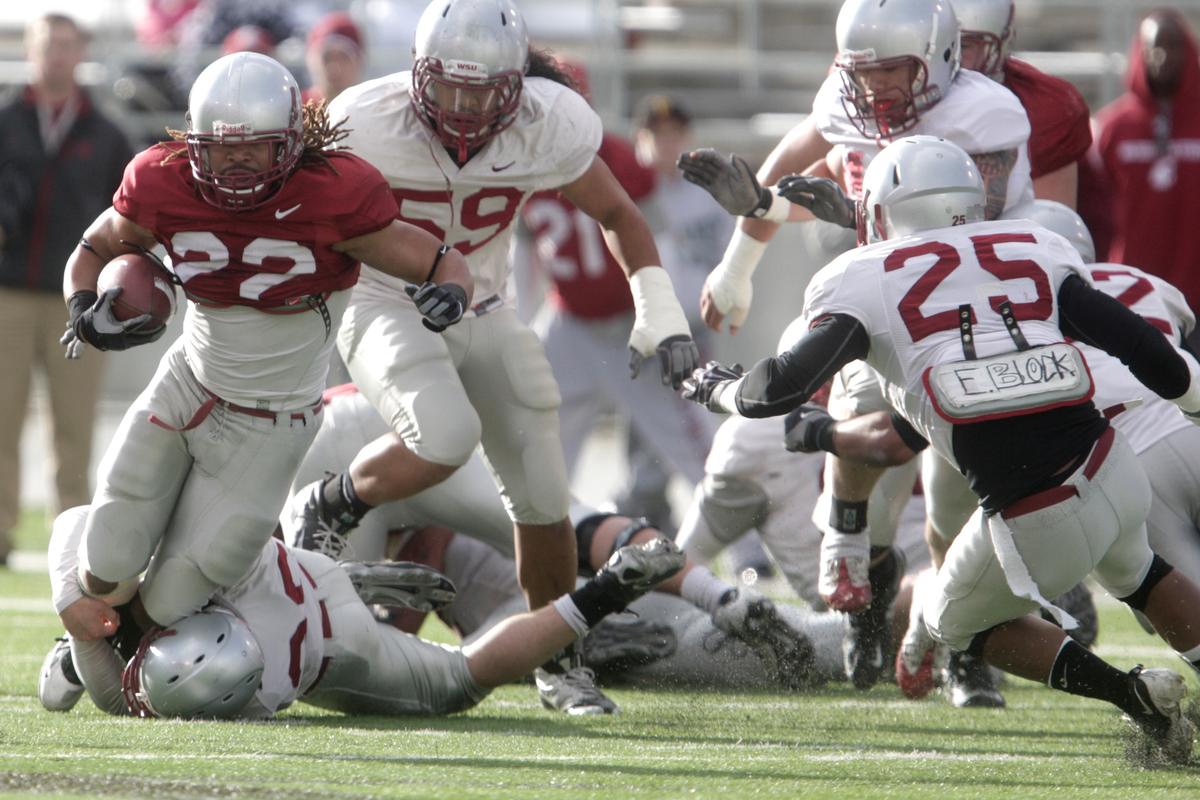 Freshman safety Casey Locker corrals senior running back Chantz Staden during WSU’s spring game Saturday at Martin Stadium.  (Tyler Tjomsland)