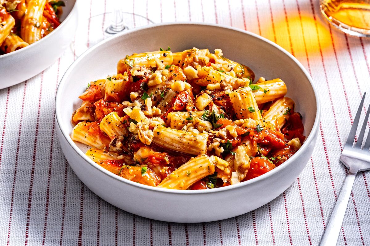 Cherry Tomato Pasta uses fresh whole cherry tomatoes that are smashed while cooking.   (Photo by Scott Suchman; food styling by Lisa Cherkasky/Both for The Washington Post)