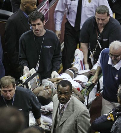 Pistons guard Rodney Stuckey is carried out on a stretcher after collapsing on the Detroit bench during the third quarter. (Associated Press)
